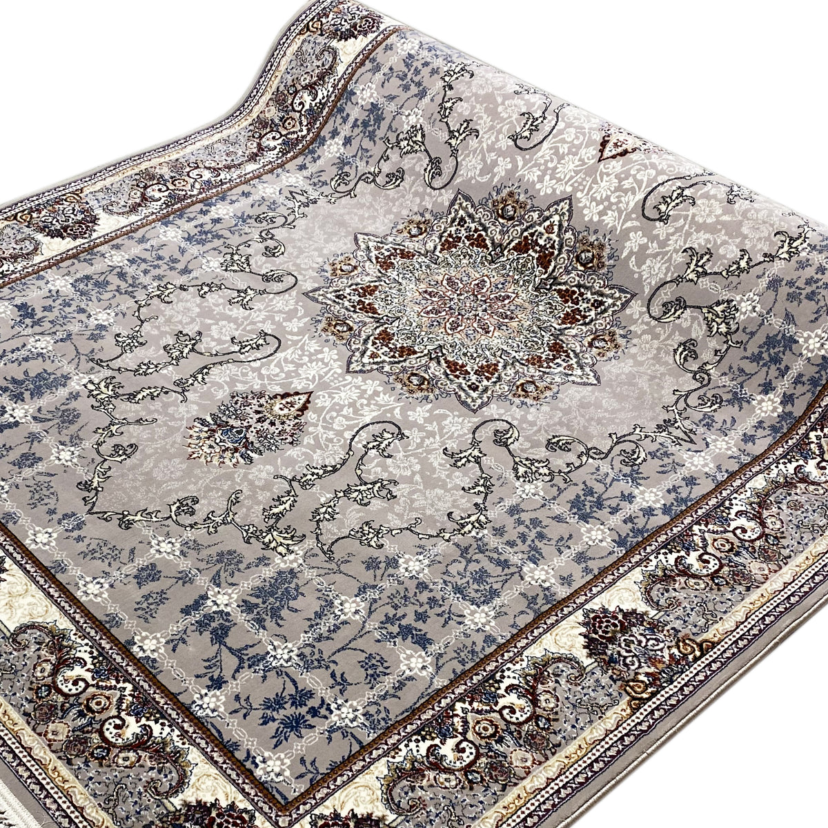 Close-up: Nain rug with a blue ornamental pattern and central medallion, framed by a border