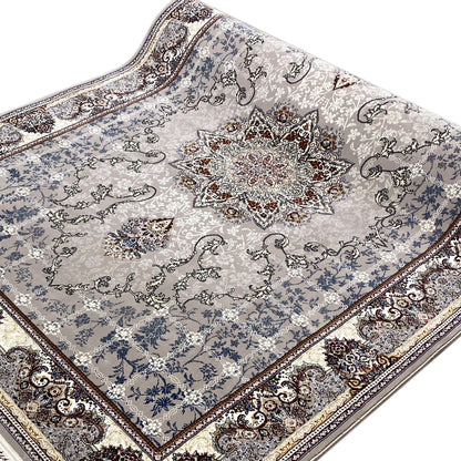 Close-up: Nain rug with a blue ornamental pattern and central medallion, framed by a border