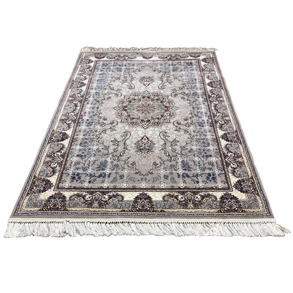 Nain rug in the image: light blue-gray medallion ornament, decorative border, and fringed edge