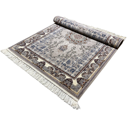 Nain rug rolled out with the rolled section at the top: blue medallion pattern, fringes along the edge