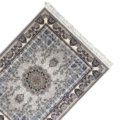 Diagonal view: Nain rug with a blue ornamental field, central medallion, and fringe
