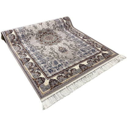 Nain rug laid flat: blue patterned field with medallion, surrounding border, fringes