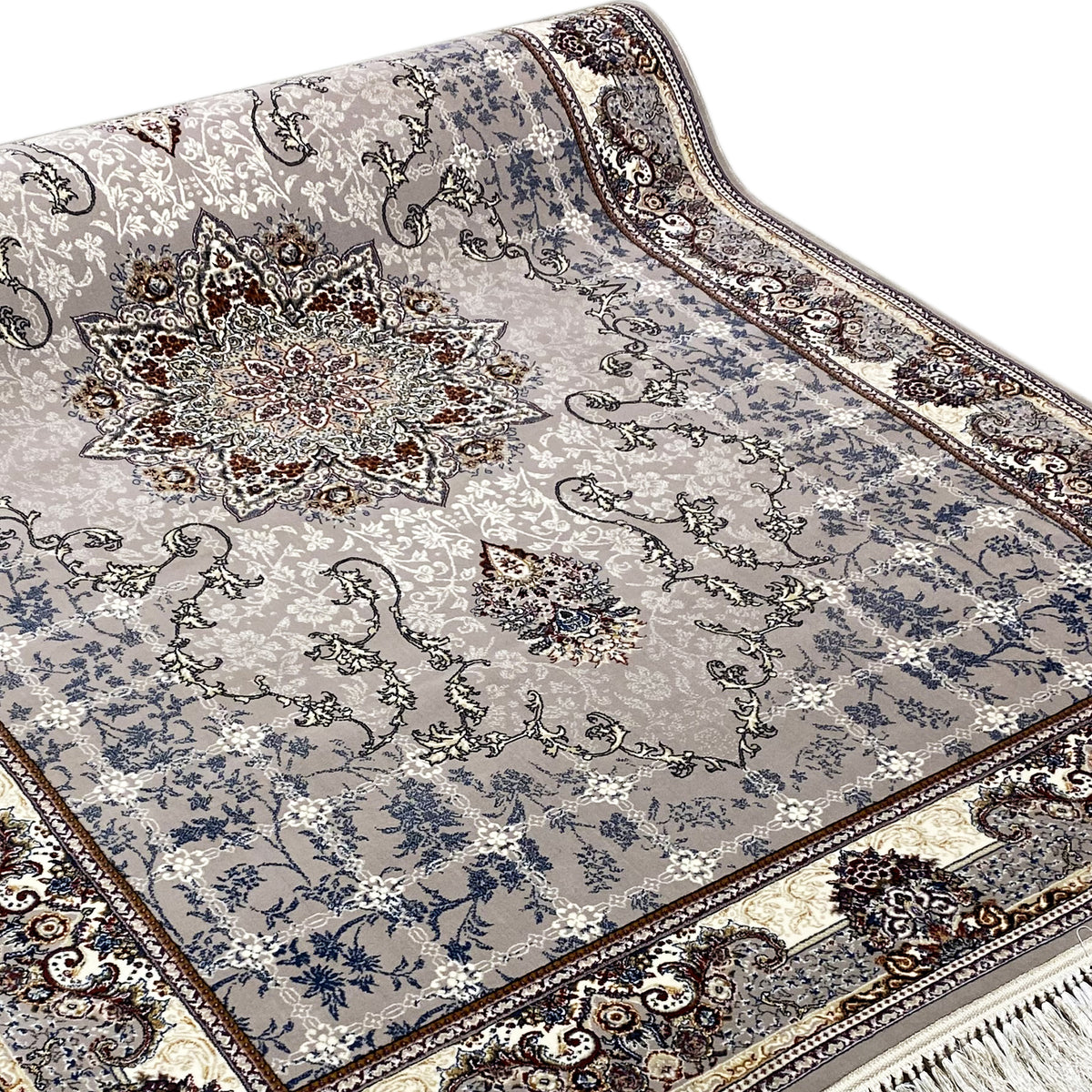 Rug detail: central medallion and floral motifs in blue-gray with a dark border