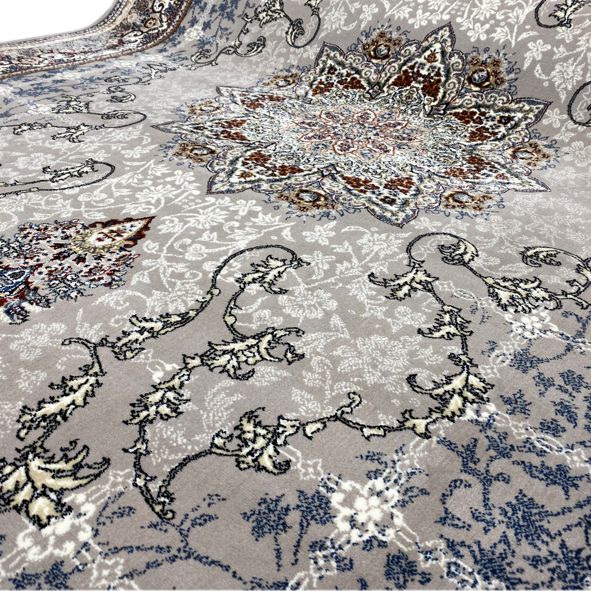 Rug surface with delicate ornaments, a light blue-gray background and a medallion in the center