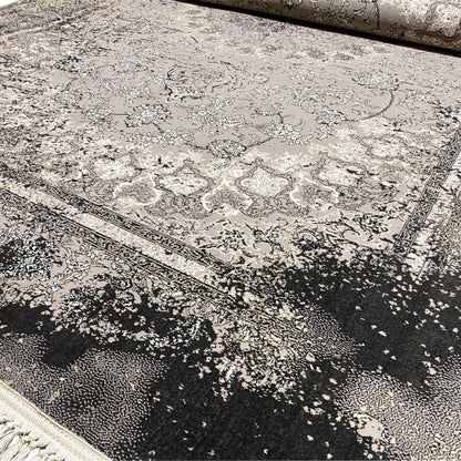 Detail view: Vintage rug in gray with an ornamental field and dark speckled border
