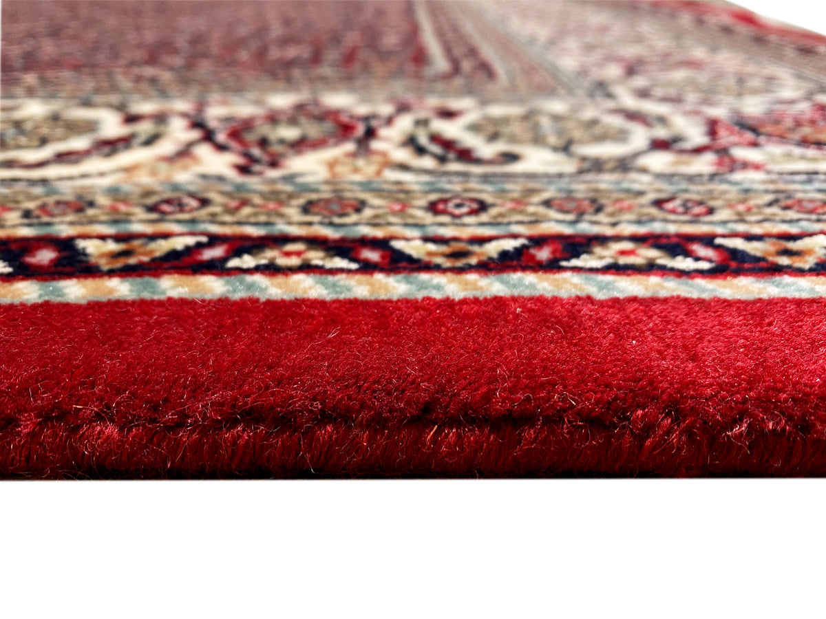 Carpet 244x170 cm close-up: dense red pile with a patterned border