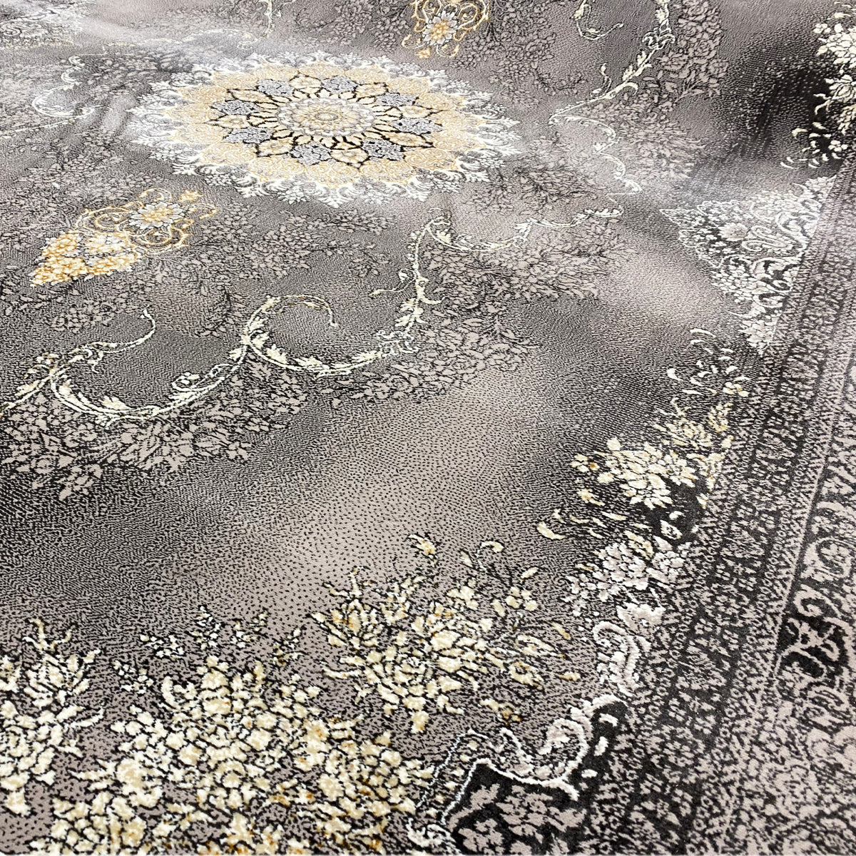 Close-up of Kashan rug: gray pile with floral ornaments in gold and beige