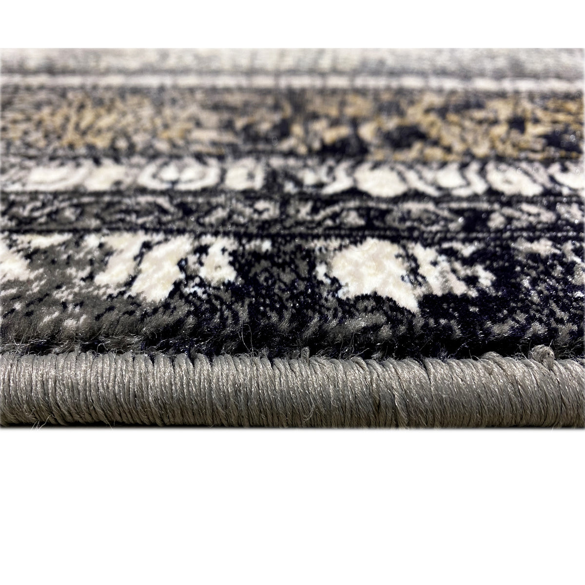 Vienna Oriental rug detail: dark ornamental pattern with fringed edging