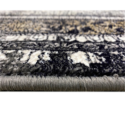 Vienna Oriental rug detail: dark ornamental pattern with fringed edging