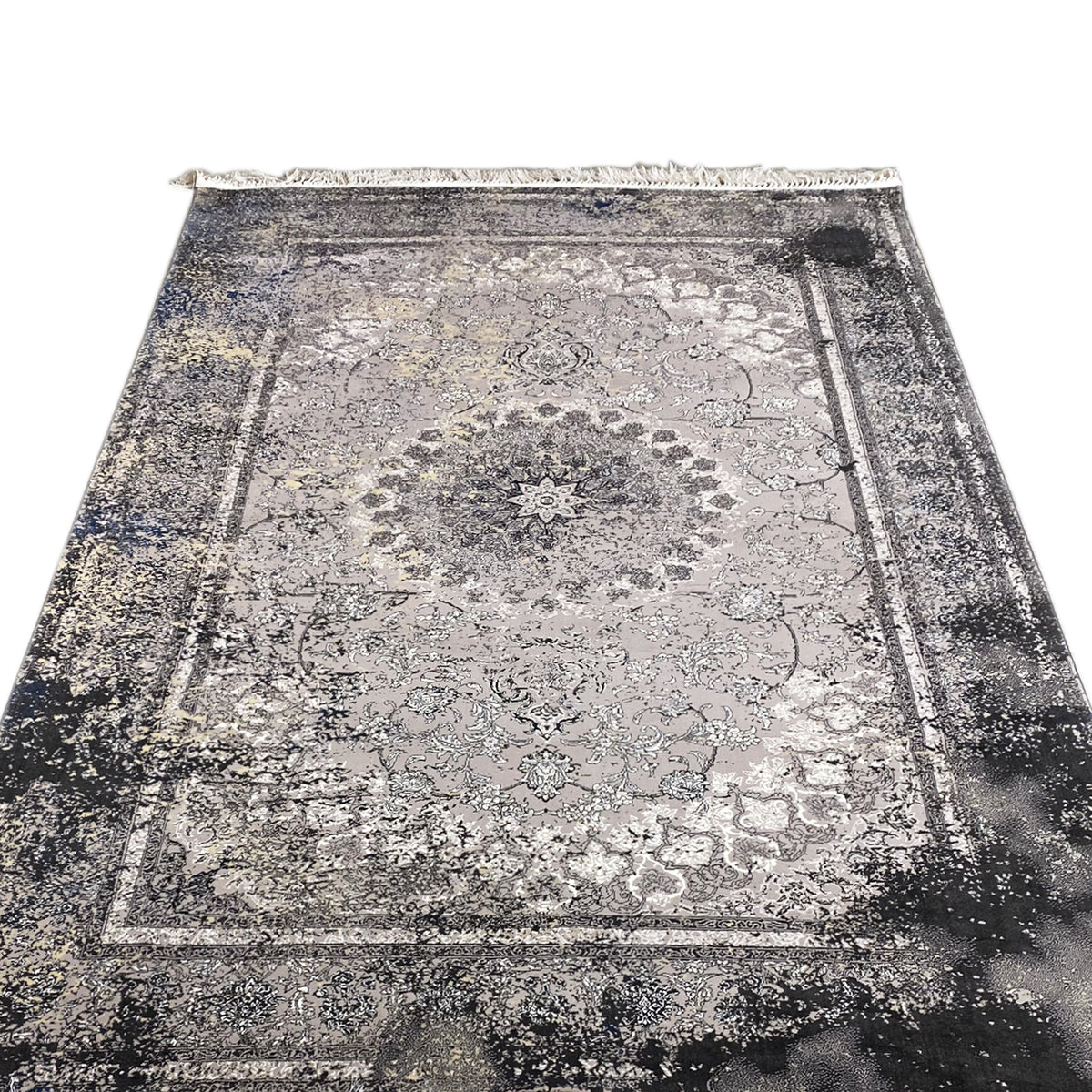 Vintage rug in gray with a central ornamental star, floral motifs, and fringes along the edge