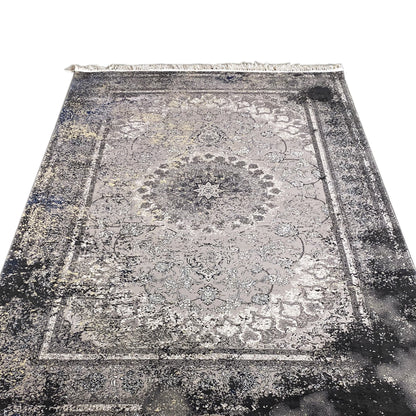 Vintage rug in gray with a central ornamental star, floral motifs, and fringes along the edge