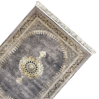Rug with a medallion pattern, gray mottled design, golden decorative borders, and fringe along the edge