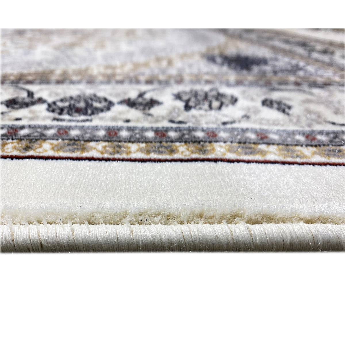 Oriental rug edging with fringes, cream-colored base, dark blue/gold ornaments