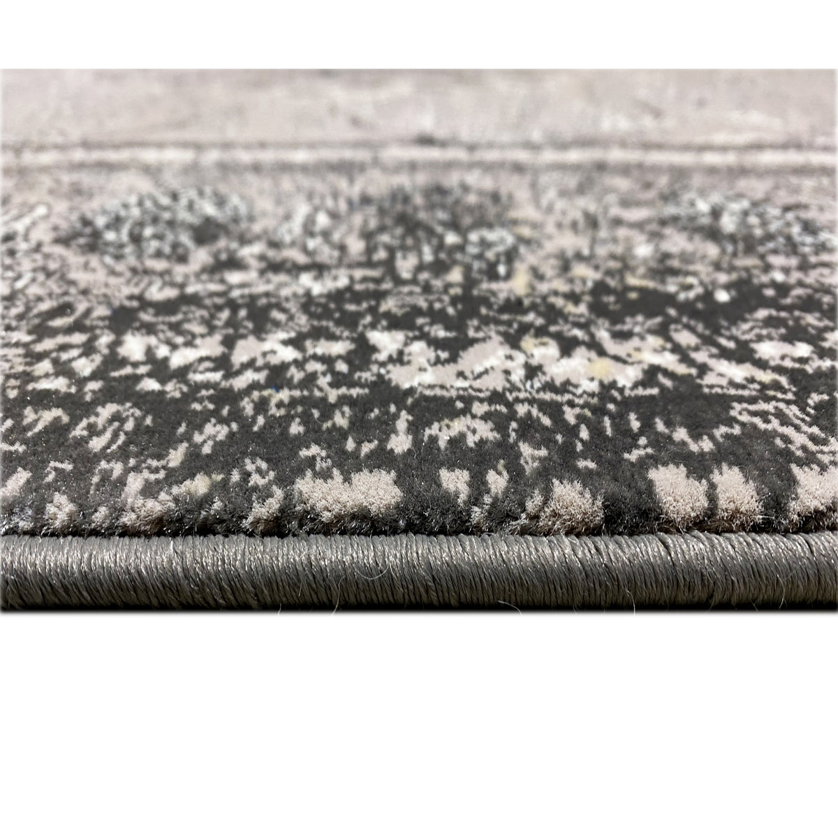 Close-up of the carpet edge: vintage carpet with fringes and a speckled look