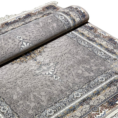 Anthracite-colored rug with medallion pattern and ornamental border, rolled