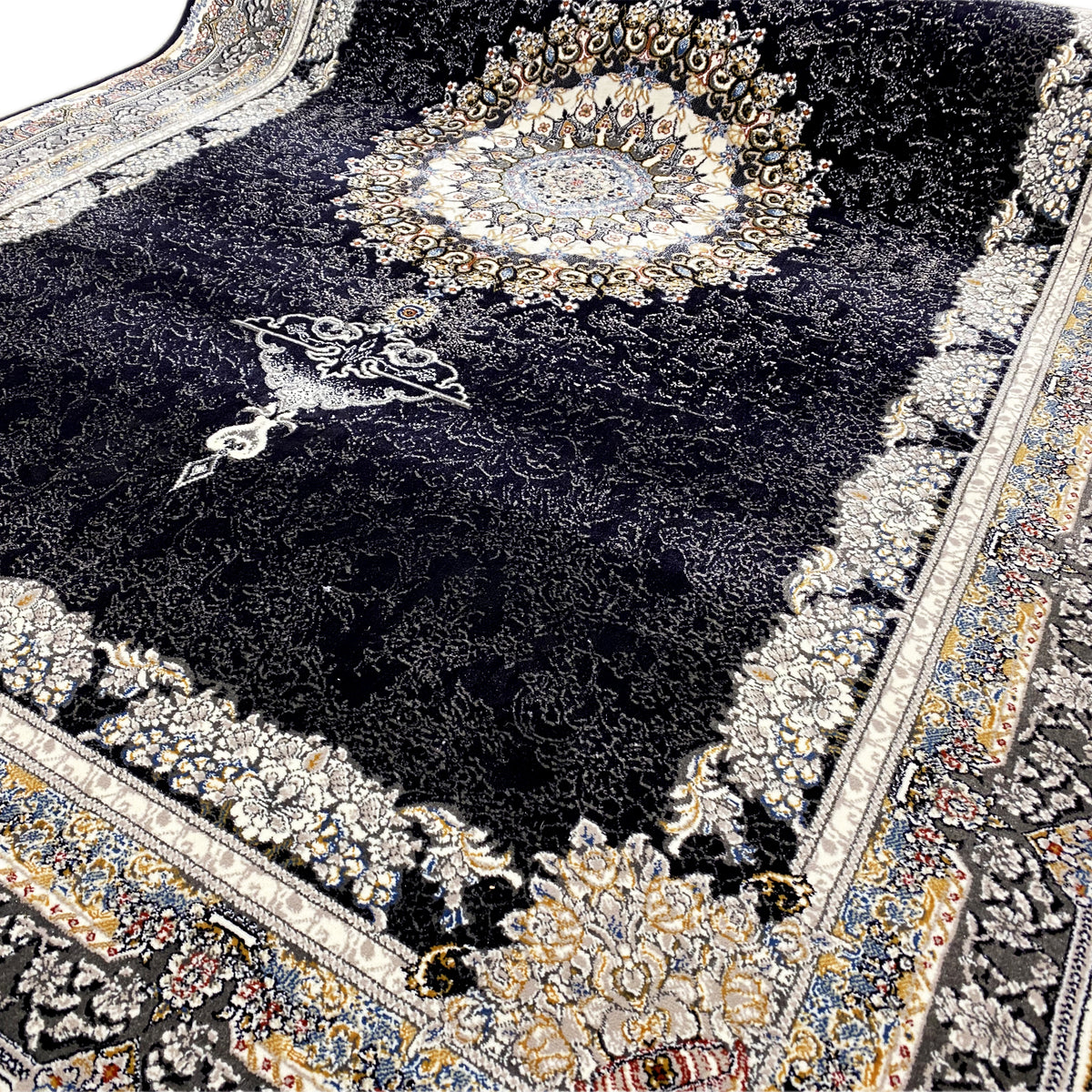 Close-up: black rug with gold ornaments, a medallion in the center, and a fringed edge