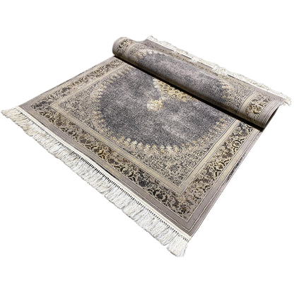 Rug spread out with fringe and medallion pattern, mottled gray, gold ornaments