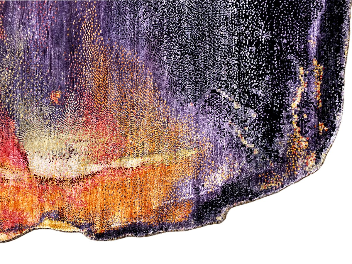 Close-up of a designer rug: textured weave with purple, orange, and cream accents.