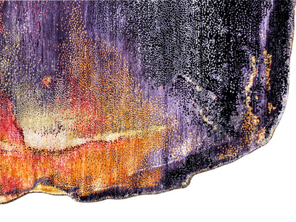 Close-up of a designer rug: textured weave with purple, orange, and cream accents.