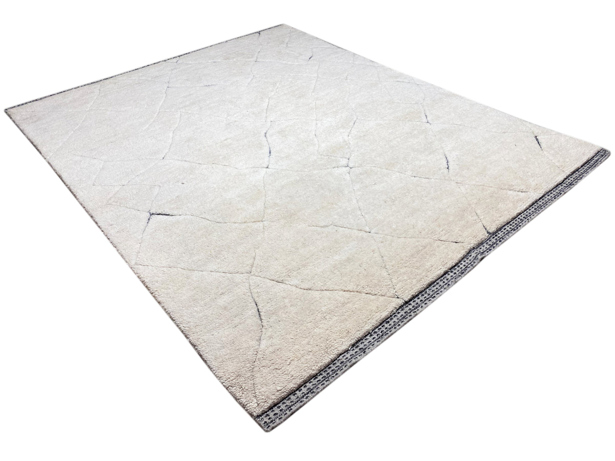 Cream Berber-style rug with blue border and linear texture