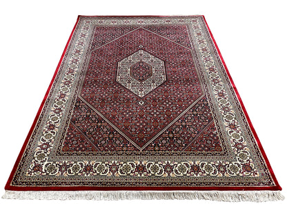 Red carpet with a central octagonal medallion, decorative border, and white fringe