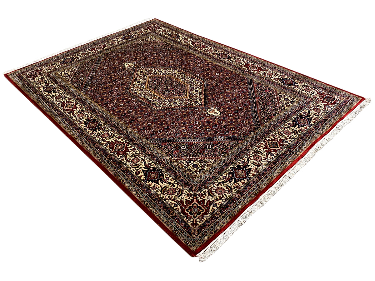 Red Bidjar rug with a woven border and white-edged sides