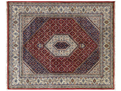 Rug with a red central field, a light medallion, and a decorative border design