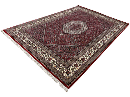 Rectangular Bidjar rug with a red central medallion and a wide cream border