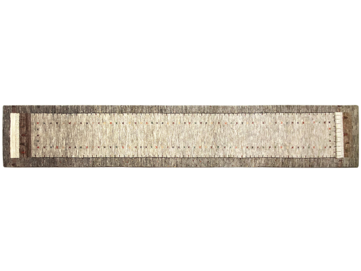 Gabbeh runner in side view with a hemmed edge and fine, even pile