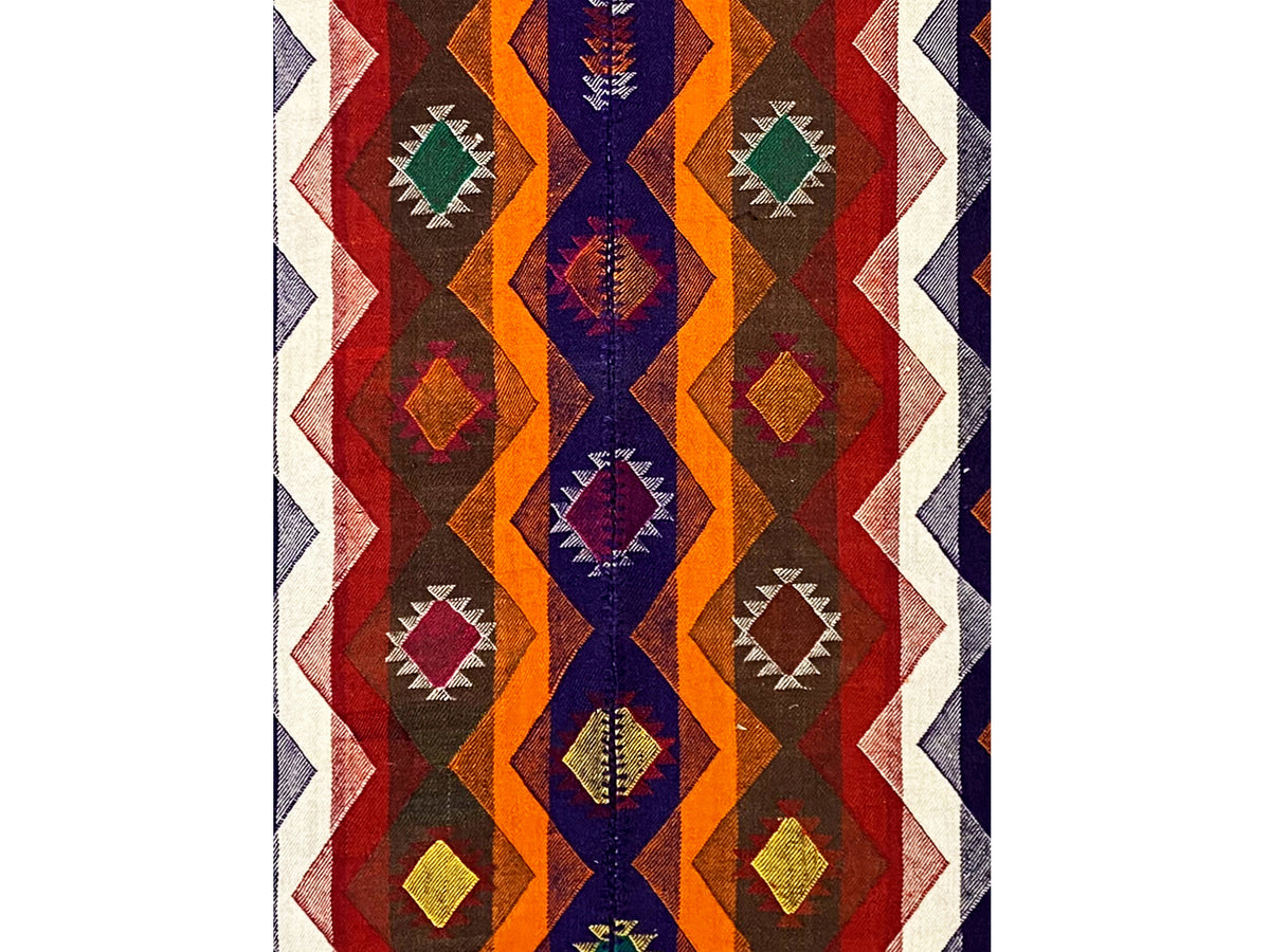 Jajim rug with an upright diamond and zigzag pattern in red, blue, orange, and green