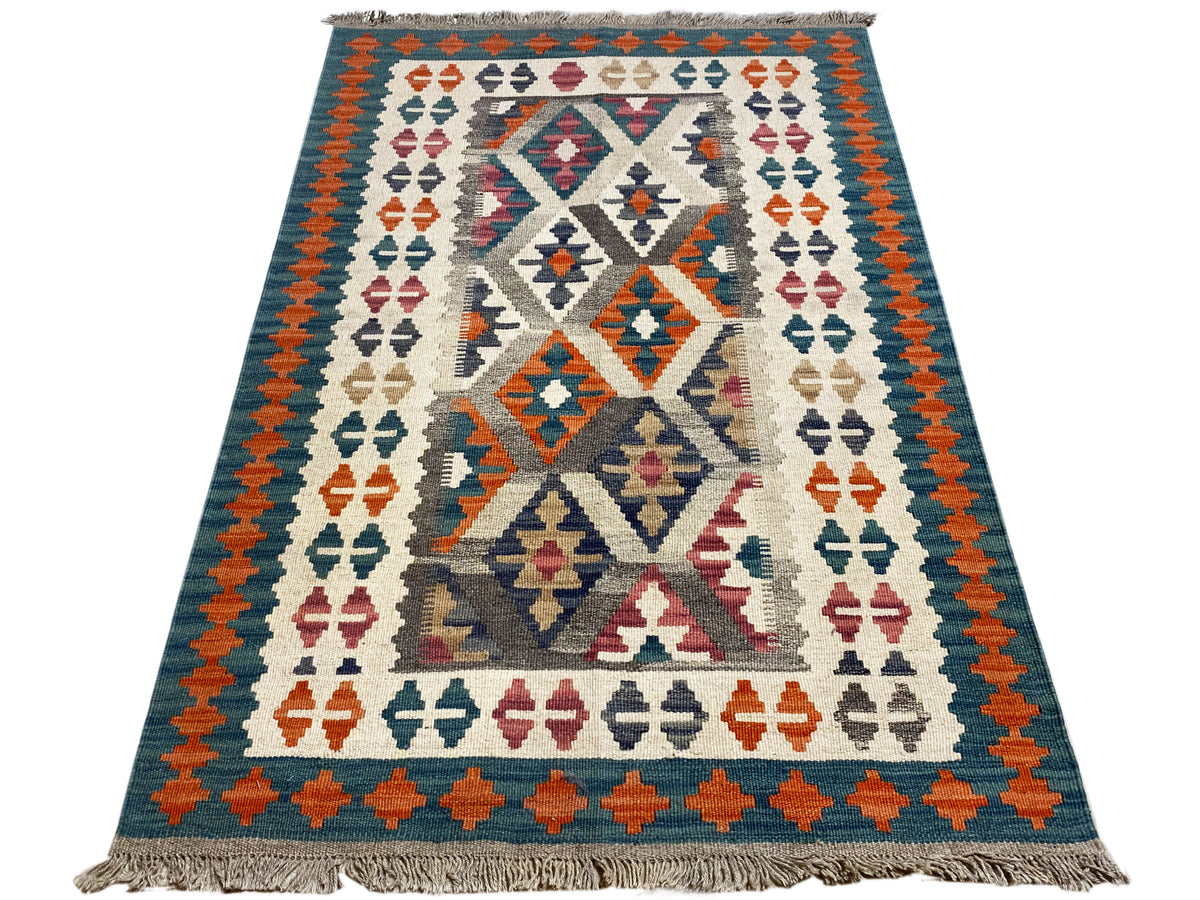 Kilim rug with a colorful central medallion and surrounding border, fringes along the edges