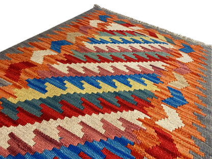 Kelim Qashqai rug, orange zigzag pattern with colorful accents and fringes, 121x78 cm