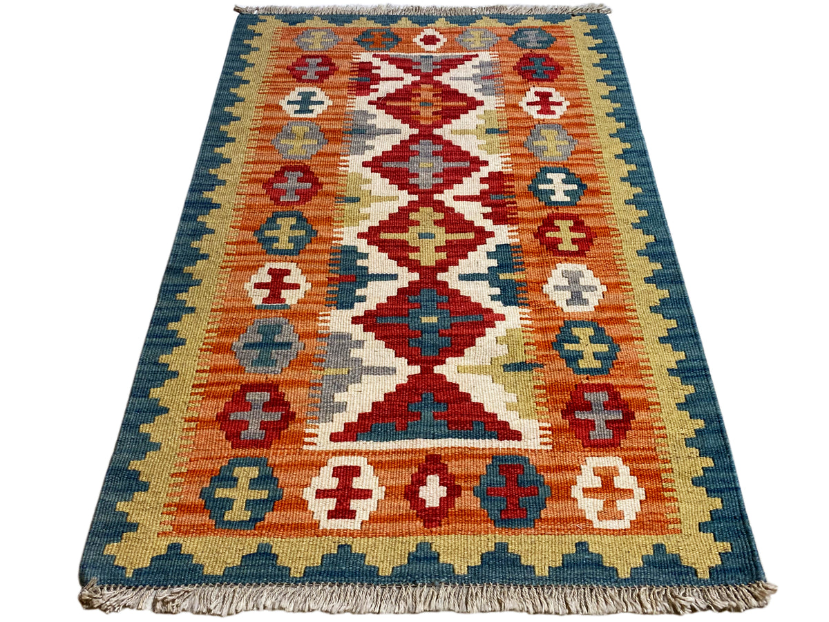 Qashqai kilim rug with diamond cross pattern, blue-and-yellow border, and orange accents