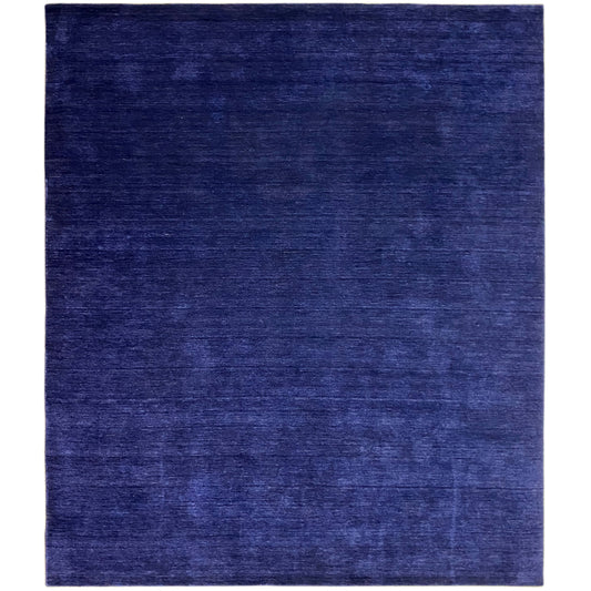 Blue rectangular rug with a matte surface and fine, subtle pattern.