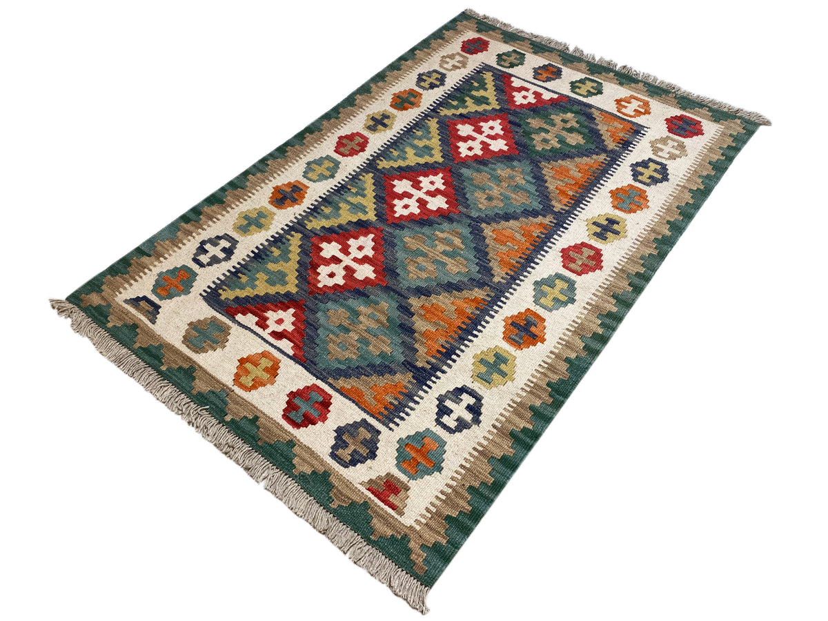 Kilim rug with a geometric pattern in shades of green and white, with fringes
