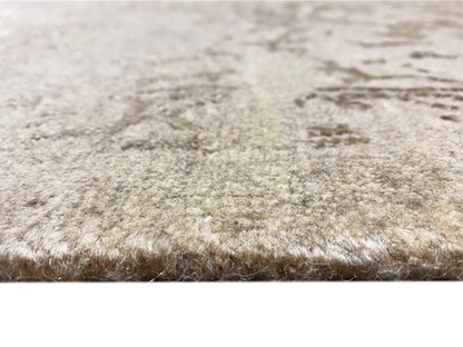 Designer rug with a soft, light beige pile and a dense, vintage-colored texture