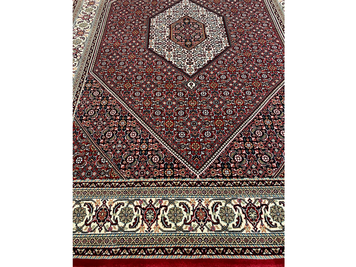 Rug 244x170 cm front view with red diamond design and border