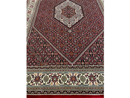 Rug 244x170 cm front view with red diamond design and border