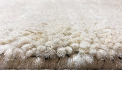 Side view: dense cream-colored pile with a blue lower edge