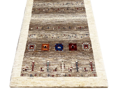 Gabbeh runner rug, front view: beige border, gray-brown striped pattern with colorful fields