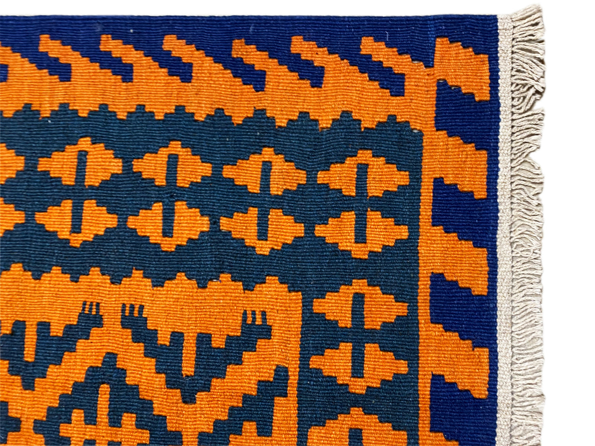 Kilim rug corner with geometric cross and zigzag pattern, fringes