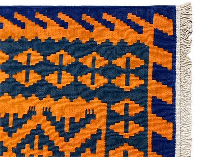 Kilim rug corner with geometric cross and zigzag pattern, fringes