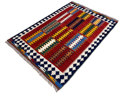 Kilim rug with a red field, multicolored grids and a blue-and-white corner pattern, fringe