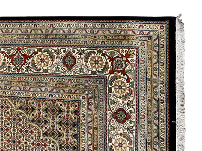 Brown Tabriz rug with finely patterned border design, close-up of the edge
