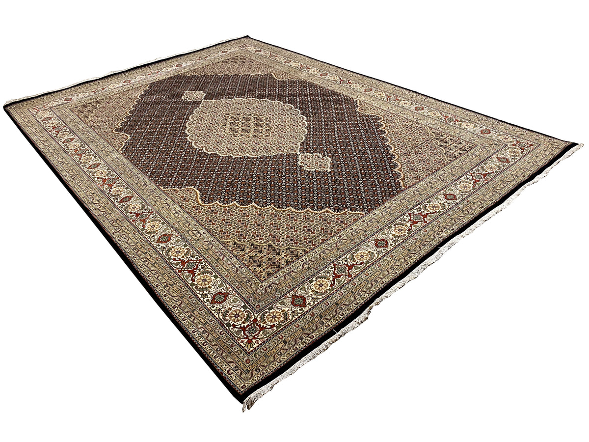 Dark brown rug with a central medallion and geometric pattern, with fringe