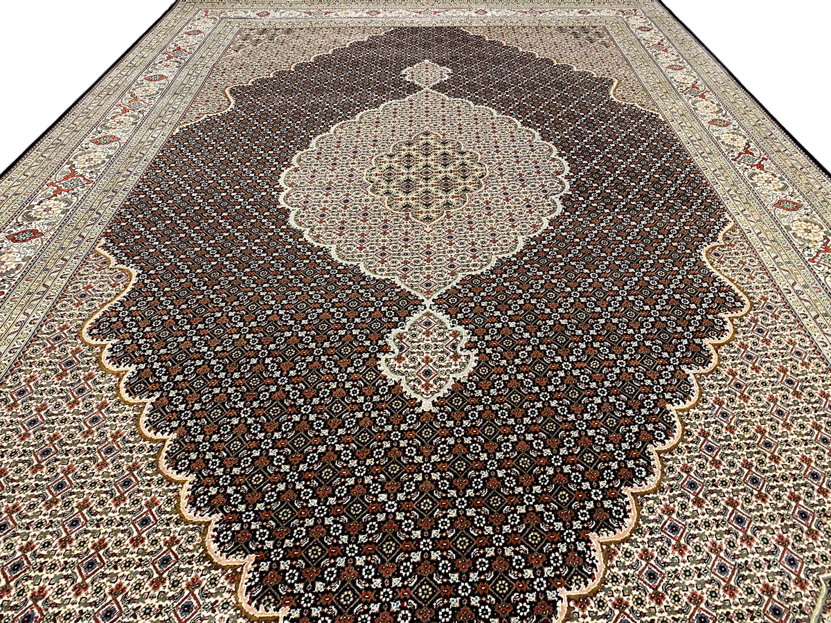 Dark brown rug with a large floral medallion and ornamental border