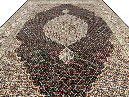 Dark brown rug with a large floral medallion and ornamental border