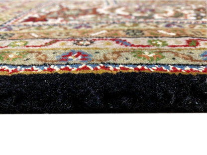 Close-up: Brown Indo-Tabriz rug with a colorful ornamental border and fringes.