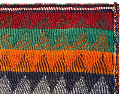 Jajim runner rug detail: multicolored stripes, zigzag pattern, bound edge