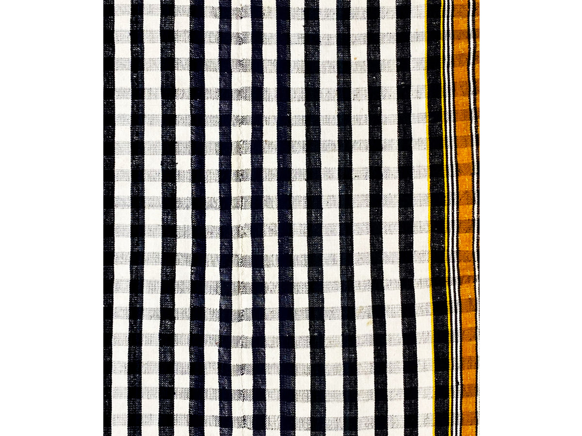 Jajim rug detail with black-and-white stripes and a narrow yellow-orange border edge